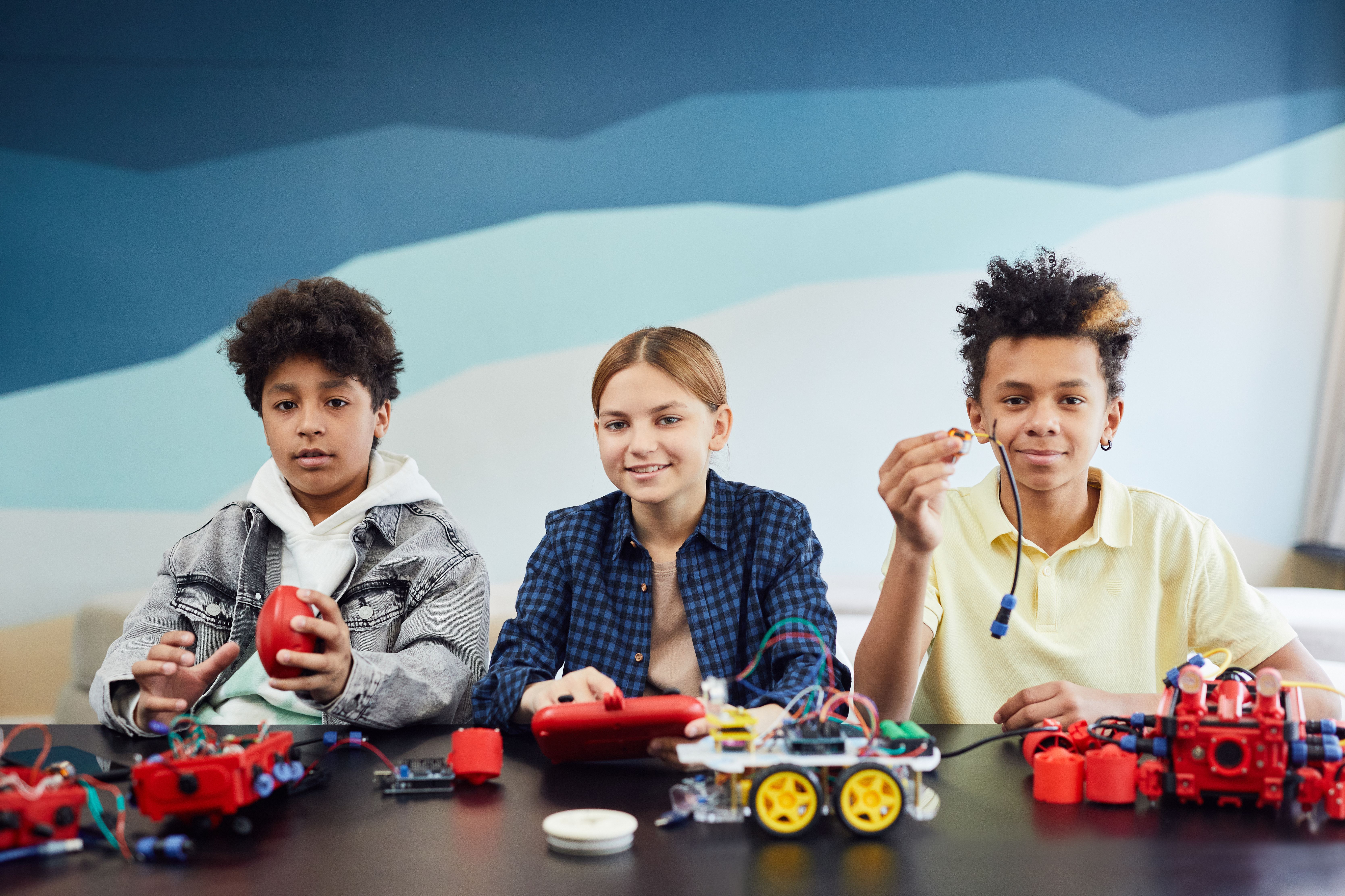 Kids building robots in a small group classroom