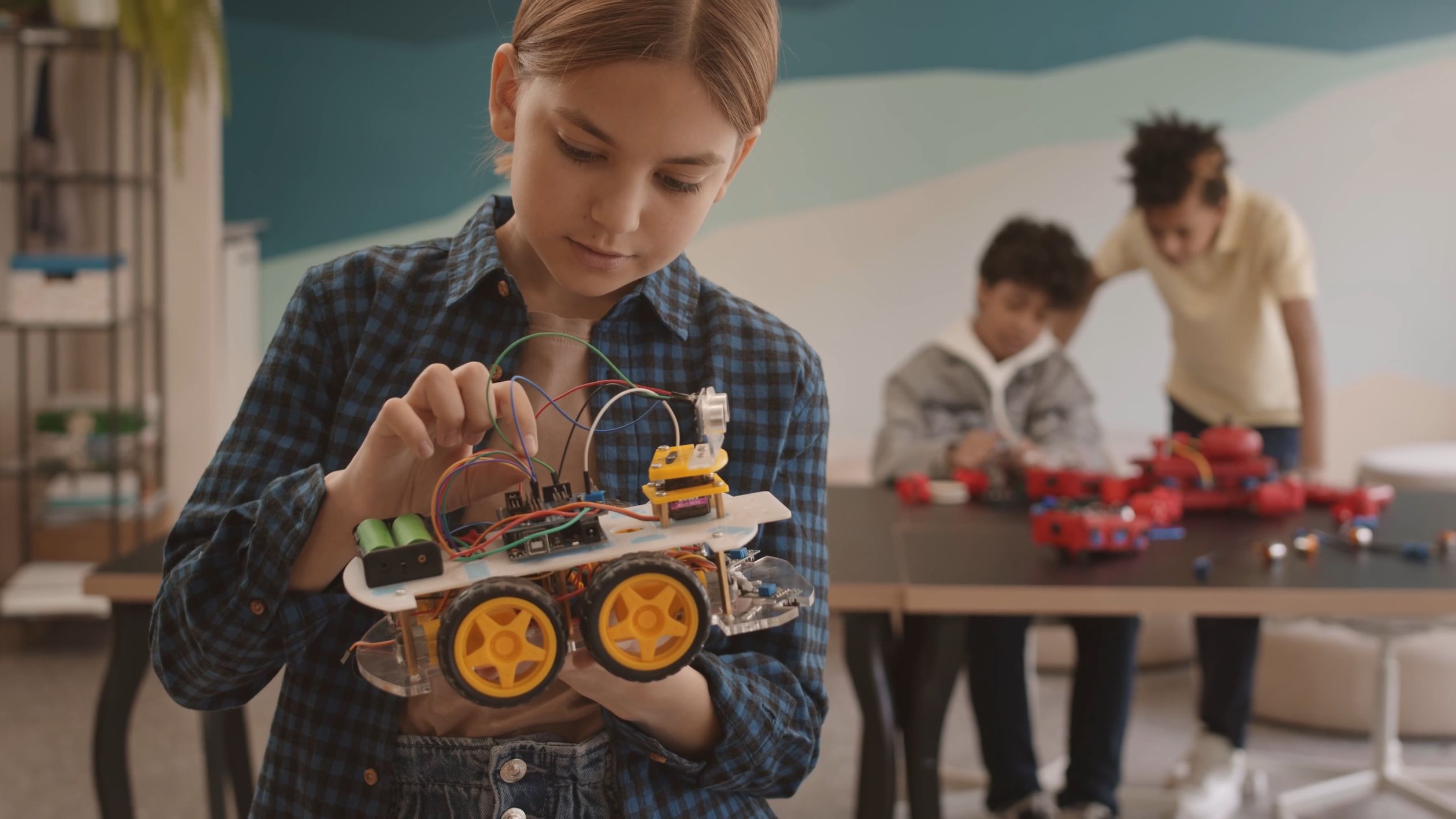 Kids working on robotics projects with an instructor